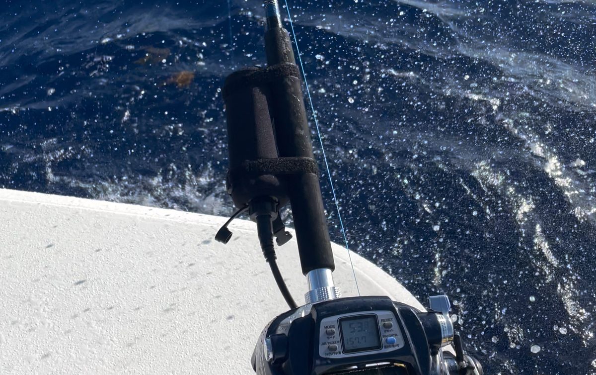 Black Oak battery in its holster on the rod, powering an electric reel offshore